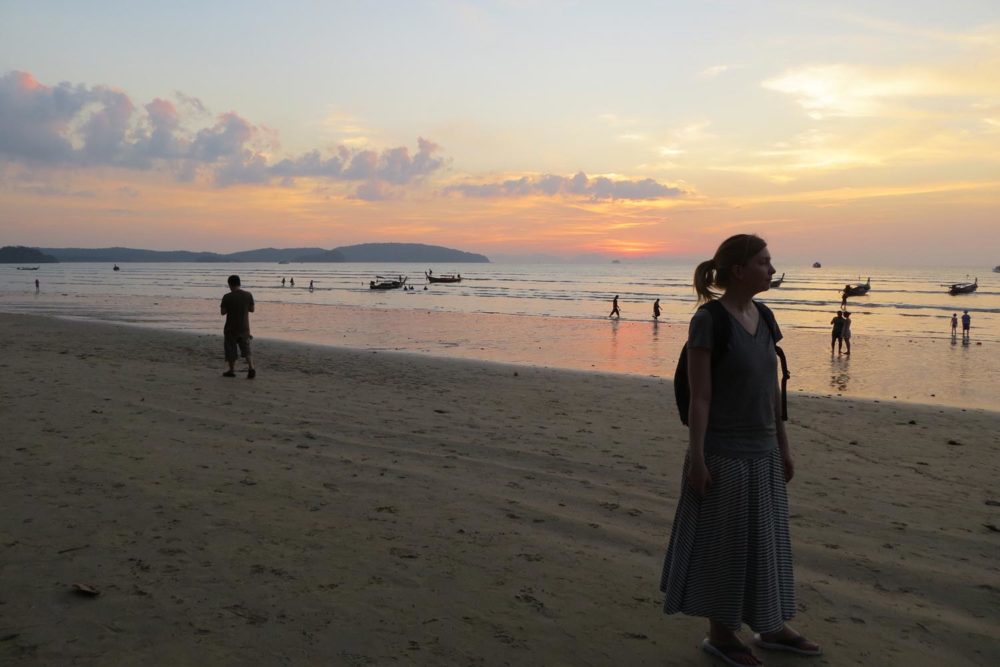 Jessica Moorhouse looking out at sunset on the beach in Thailand, reflecting on her personal finance journey